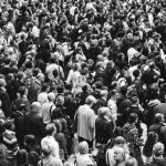 grascale photo of people standing on ground