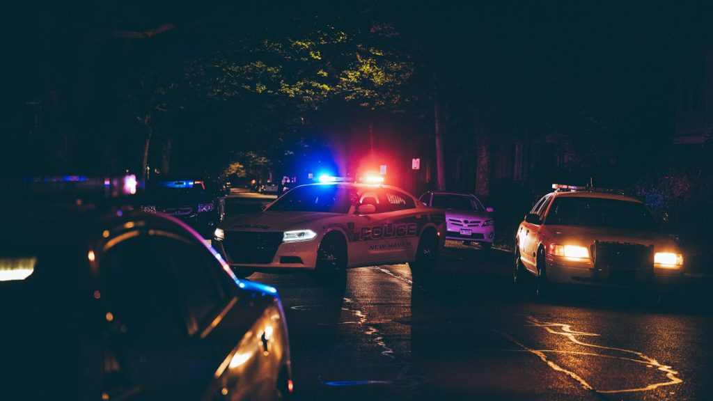 A couple of police cars parked in a parking lot